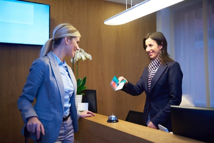 Couple on a business trip doing check-in at the hotel