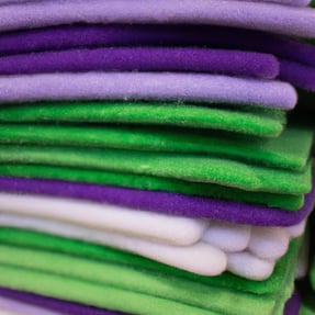 stacks of felt with the color green, purple, and white