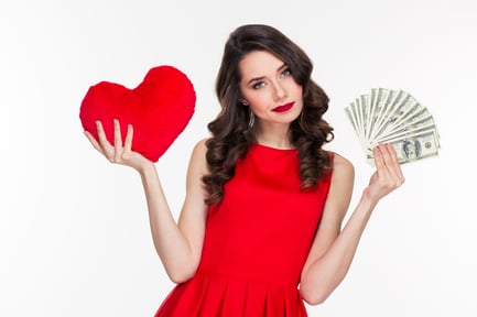 Portrait of a beautiful woman in red dress choosing between love or money isolated on a white background
